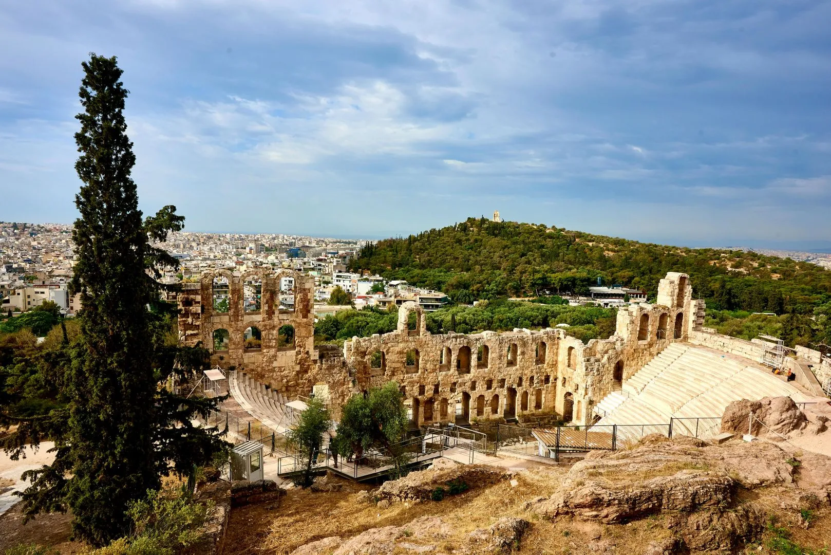 Traditional Greek culture with locals in colorful attire, enjoying music, dance, and authentic Mediterranean cuisine in a charming village setting.