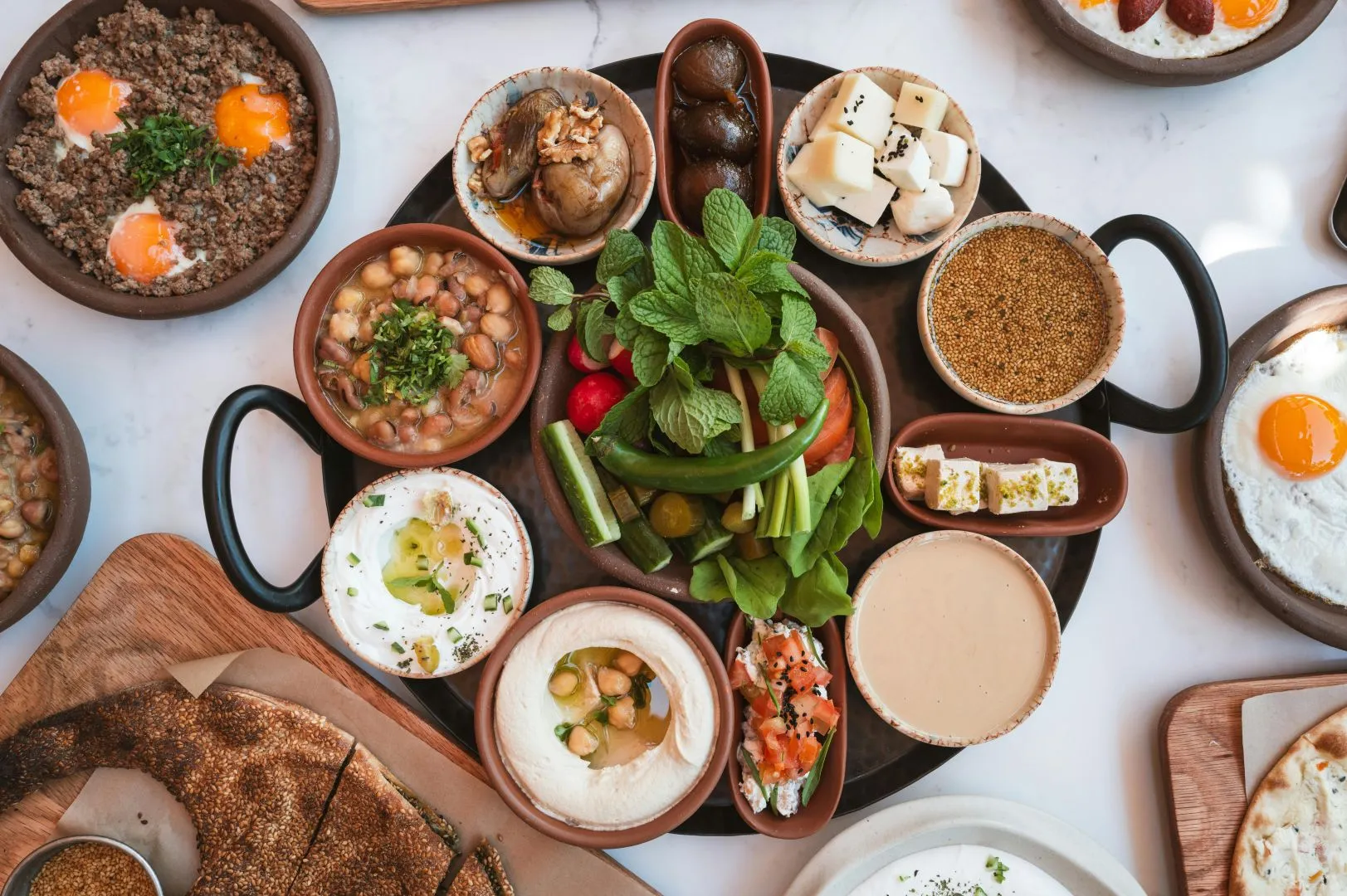 Traditional Moroccan cuisine featuring a colorful spread of tagine, couscous, fresh bread, and aromatic spices, served in decorative dishes.